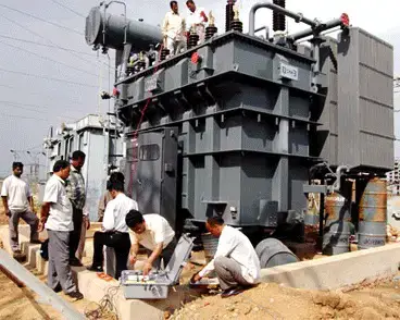 Men doing routine testing on a transformer